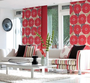 This room comes together beautifully with the unexpected gorgeous pop of floral red drapery.  The stripes in the pillows bring the design together with the black pillows grounding the design.